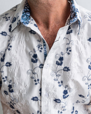 Close-up of a white shirt with blue floral patterns