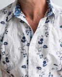 Close-up of a white shirt with blue floral patterns
