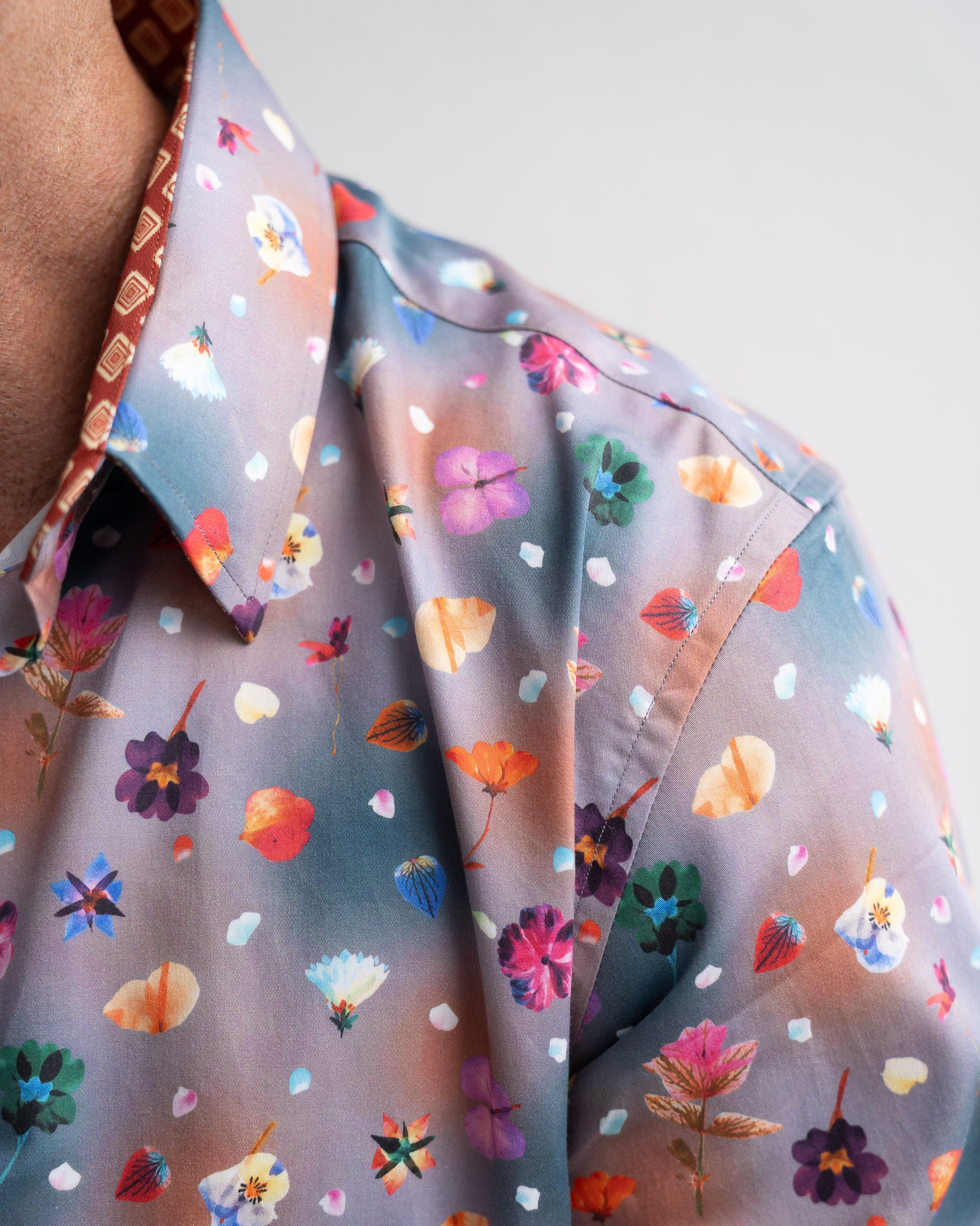 Close-up of a colourful floral floral-patterned shirt with a neutral background