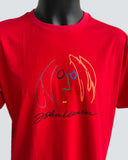 Red t-shirt with colourful John Lennon graphic and signature against a grey background