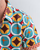 Close-up of a colorful geometric patterned shirt with a plain background