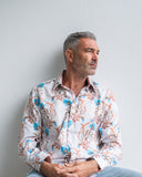 Man wearing a patterned shirt against a plain background