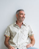 Man wearing a patterned shirt against a plain background