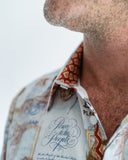 Close-up of a person wearing a patterned shirt with John Lennon lyrics.