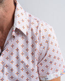 Close-up of a patterned shirt with a geometric design on a plain background
