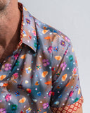 Close-up of a colourful floral-patterned shirt with a plain background